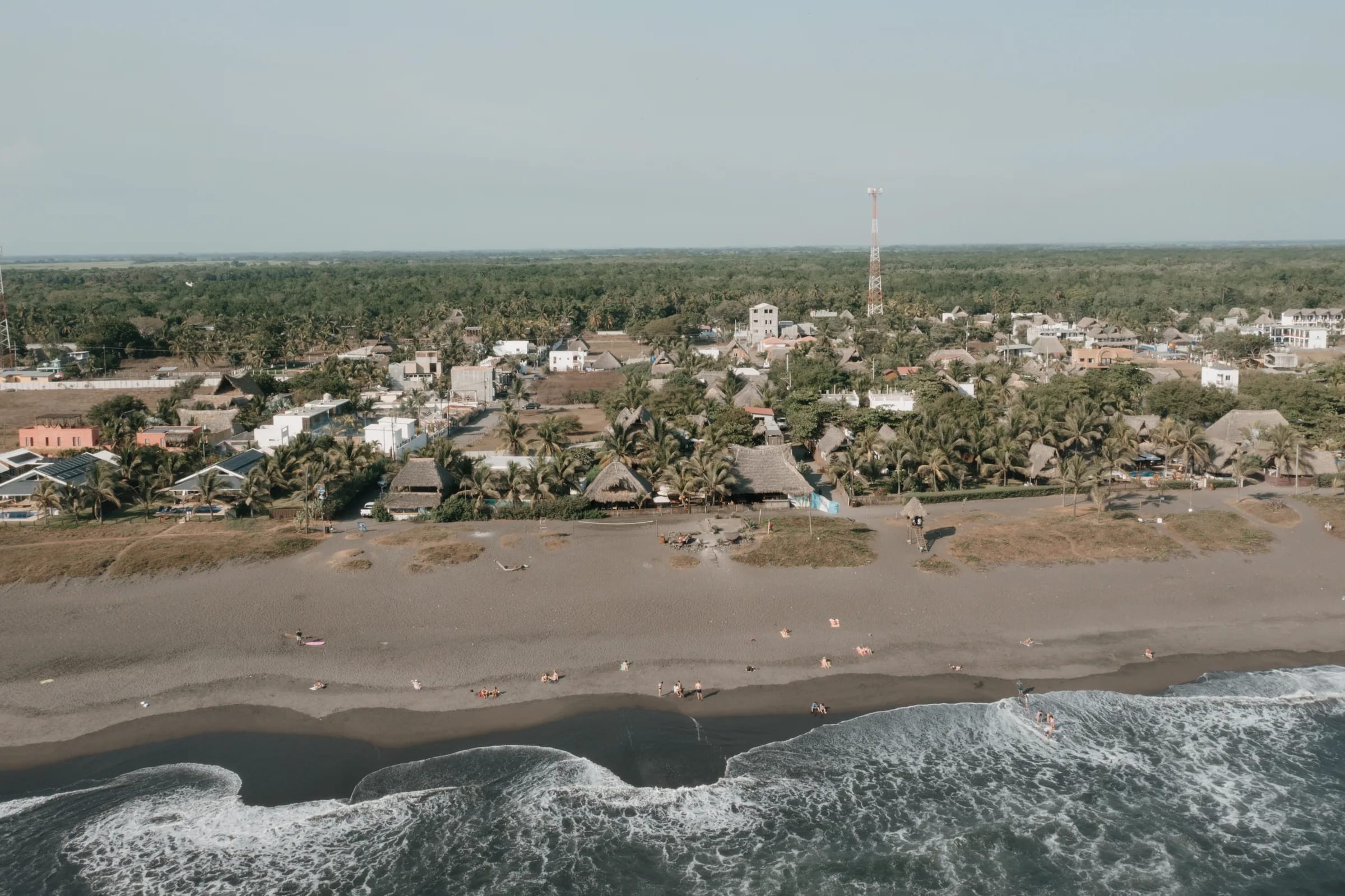Aerial view of El Paredón’s black-sand coast and the COCOLOCO campus